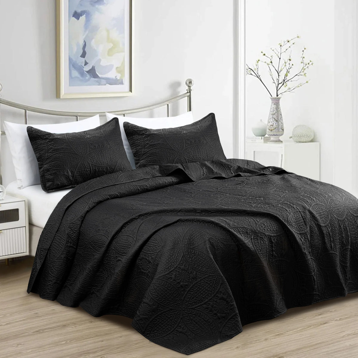 Black quilt bedding set with embossed coin pattern and matching pillowcases