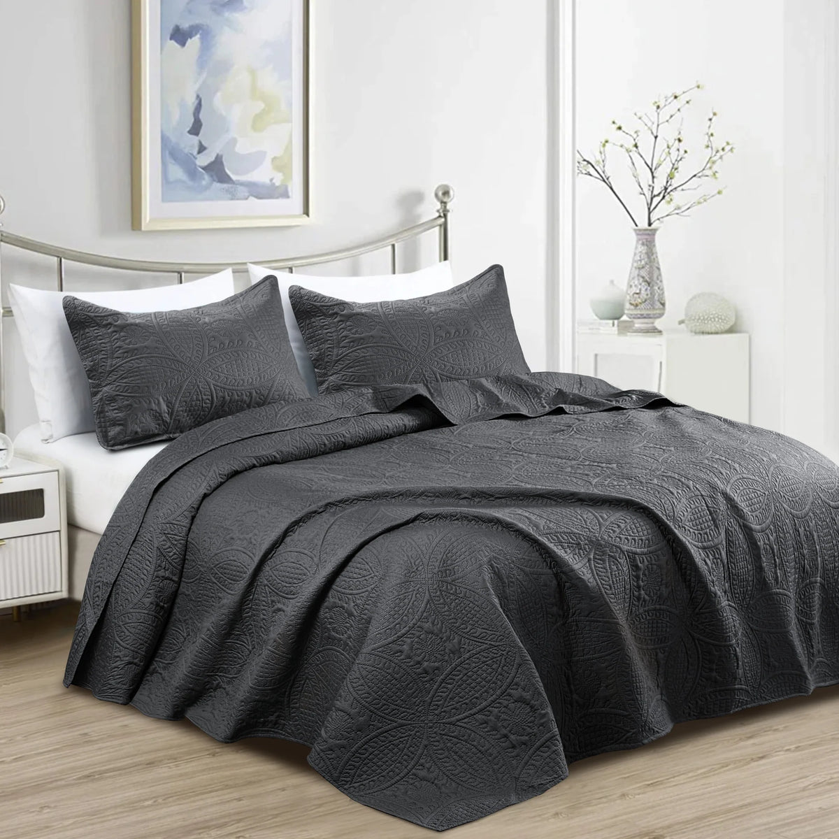 Charcoal grey quilted bedspread with matching pillowcases and embossed pattern