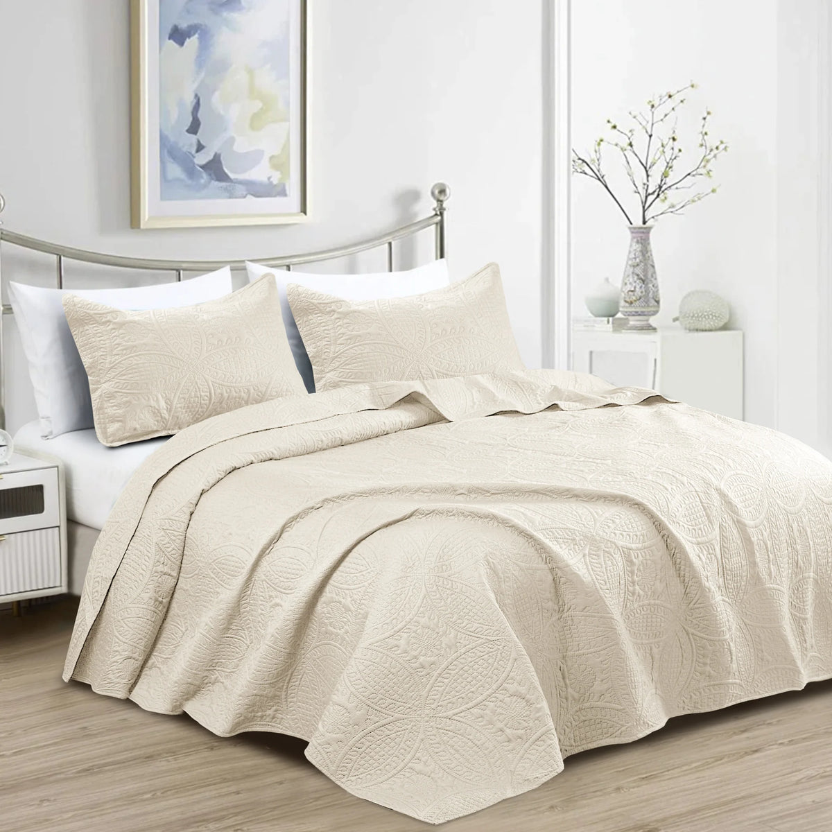 Cream quilt bedding set with embossed floral coin pattern and matching pillowcases