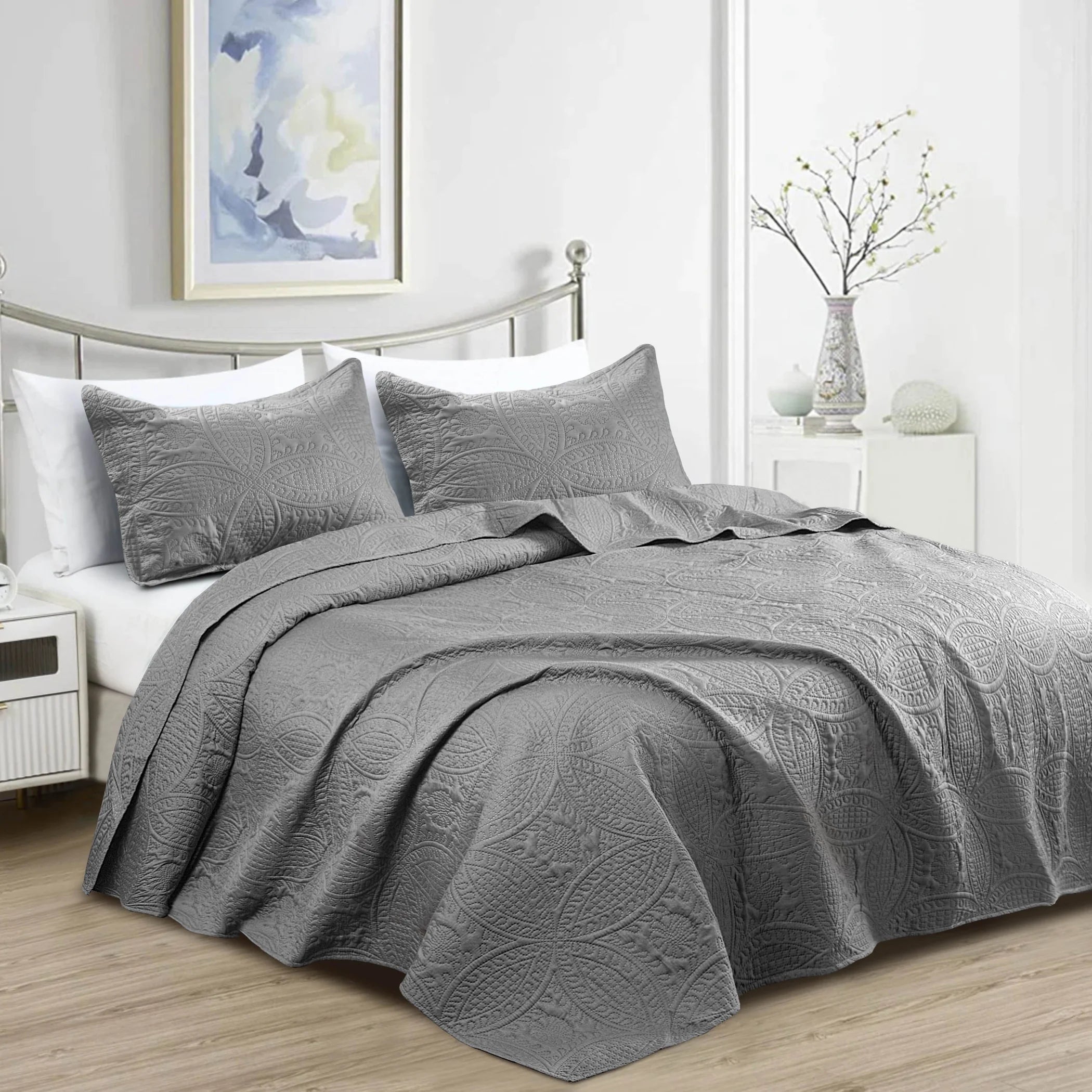 Dark charcoal grey quilted bedspread set with matching pillowcases featuring elegant embossed coin floral pattern.