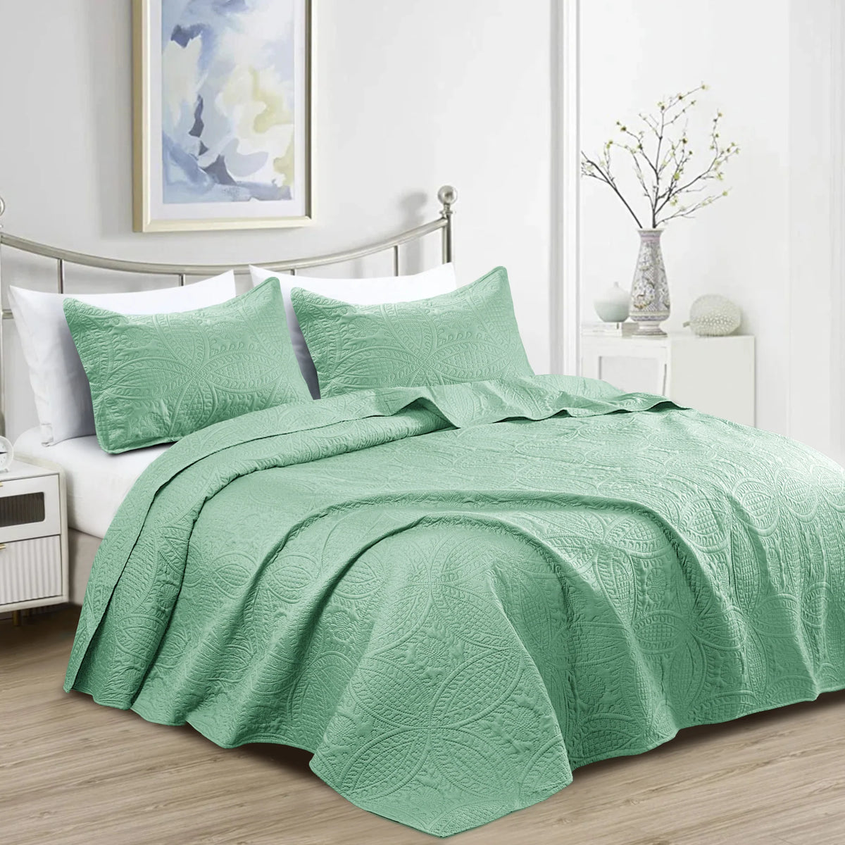 Sage green quilted bedspread set with matching pillowcases and decorative coin pattern