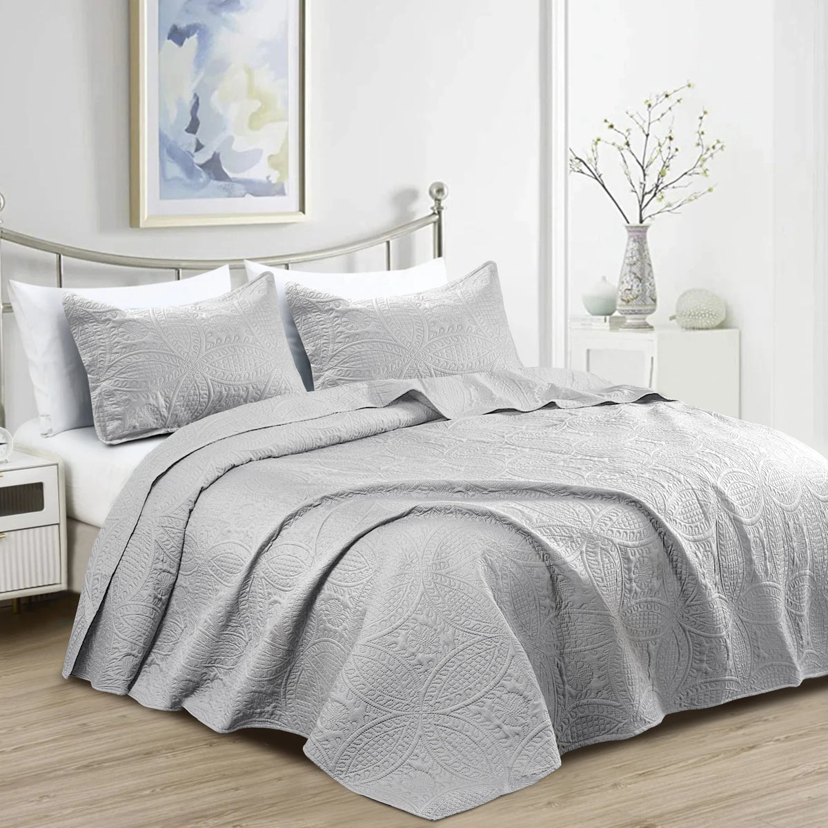 Silver grey quilt bedding set with embossed floral pattern and matching pillowcases