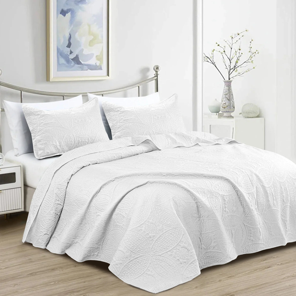 White quilted bedspread set with matching pillowcases and subtle embossed pattern